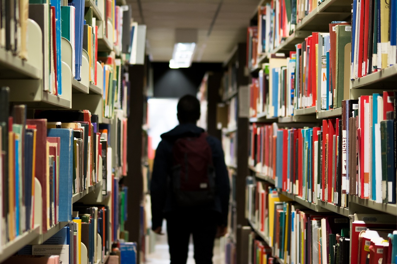An image of a person standing in a library